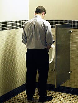 gentleman urinating in urinal